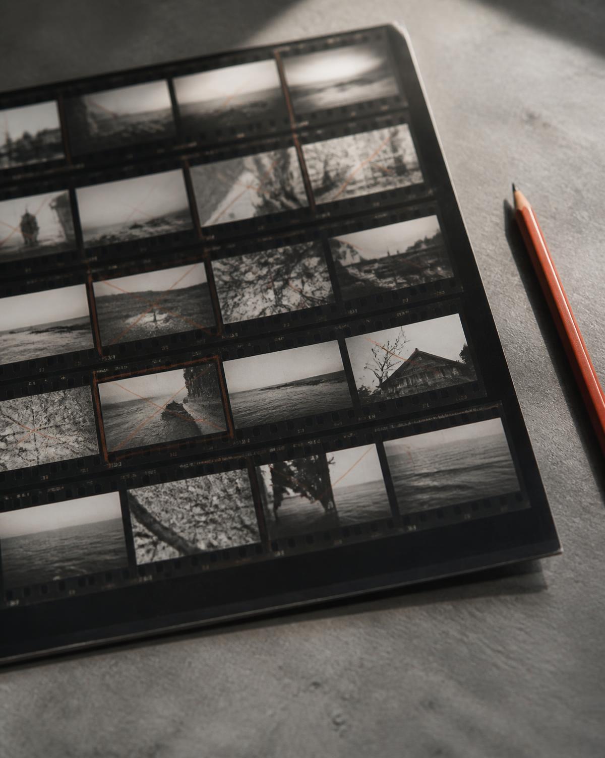 Black and white photographic contact sheet with selection marks beside a coloured pencil